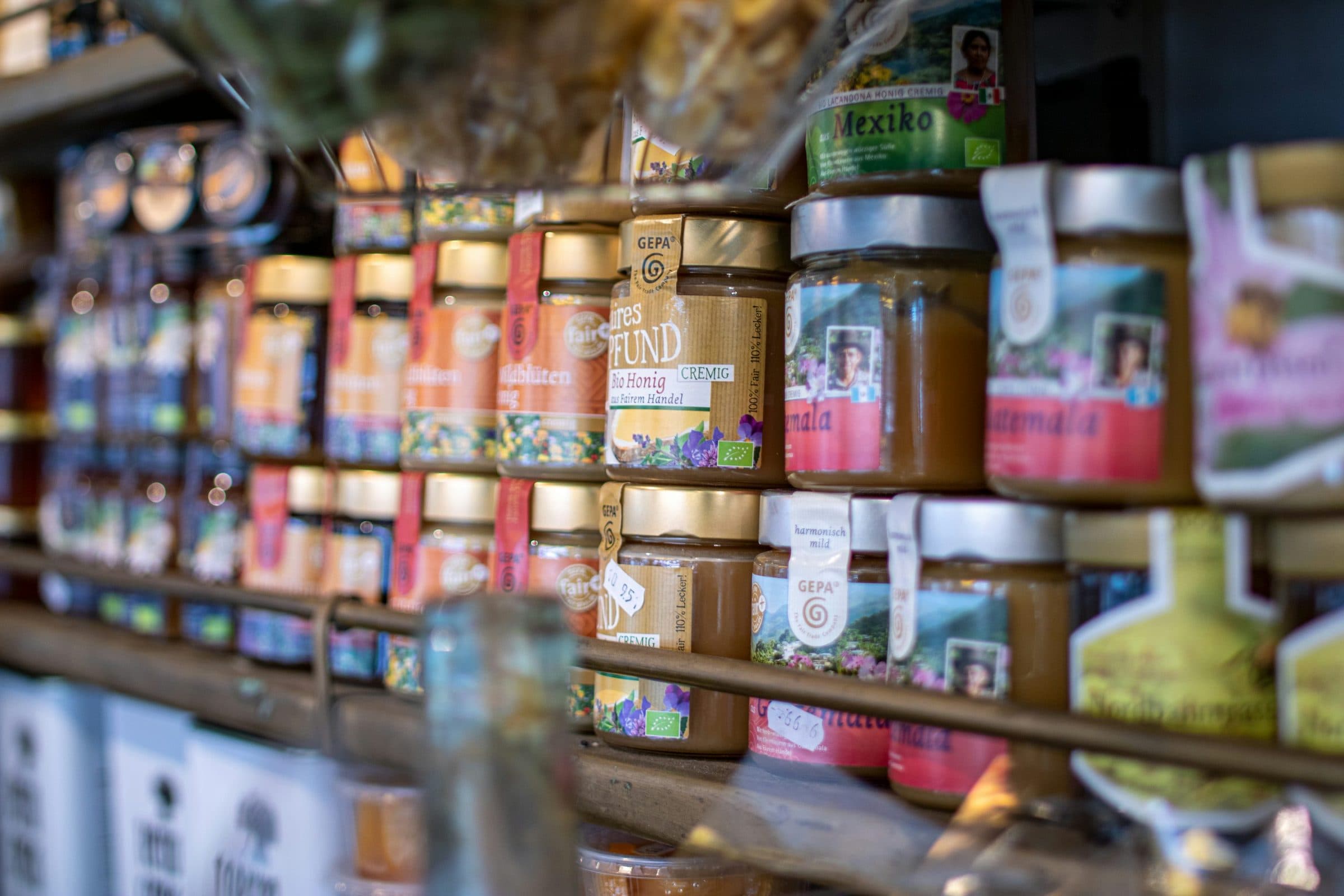 Jars of honey lined up on a shelf